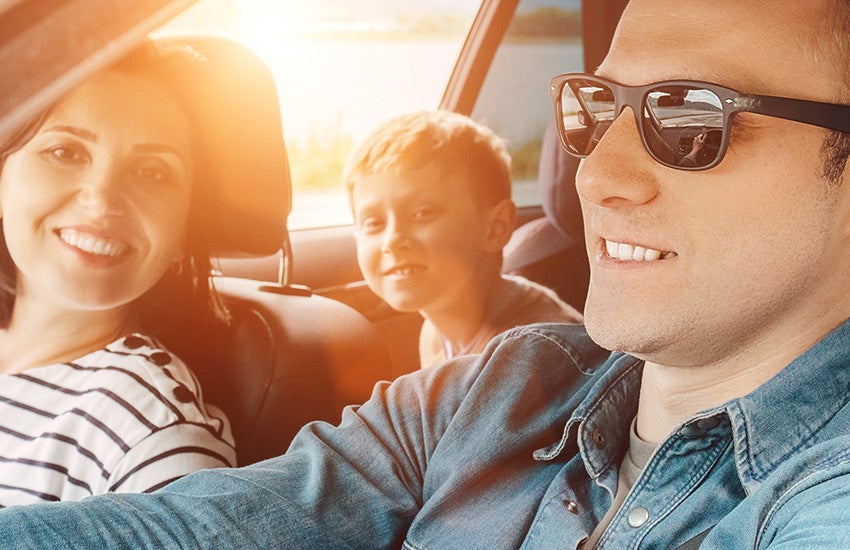 Smiling family in a car
