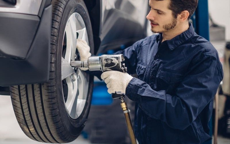Man checking car tire
